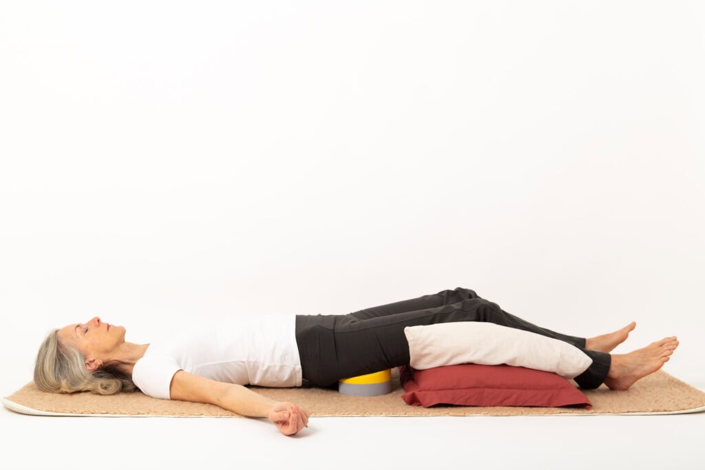 Loulou James, inventor of the Buttafly, demonstrating the Buttafly Technique for a natural release of the spine which offers a perfect way to prepare for yoga.