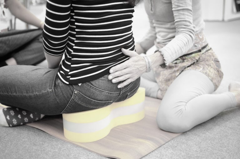 Loulou James demonstrating posture correction technique using the Buttafly method for spine health