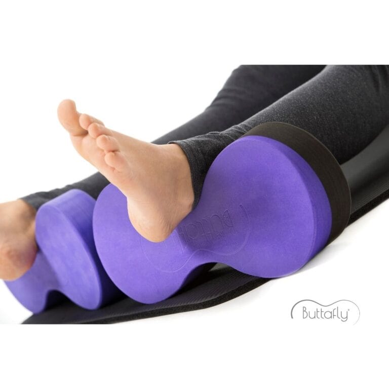 A young woman demonstrates how to use a Buttafly under each ankle to provide a comfortable variation of Supported Corpse Pose (Savasana).