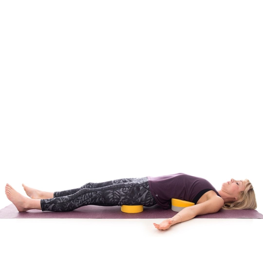 A young woman demonstrates using the Buttafly yoga block alternative in this supported heart-opening pose suitable for experienced practitioners.